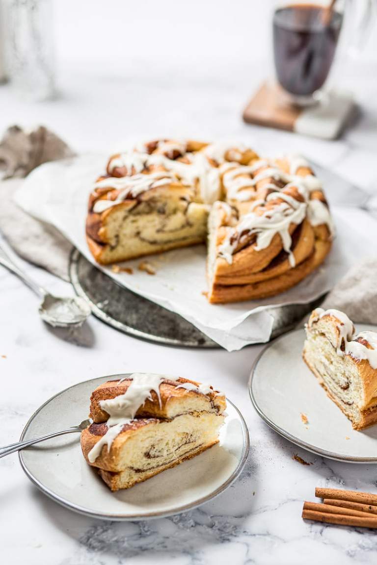 Cinnamon brioche braided loaf with slice on a plate
